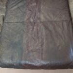 Thumbnail image of three different leather balms and paints applied to a semi-aniline leather couch cushion
