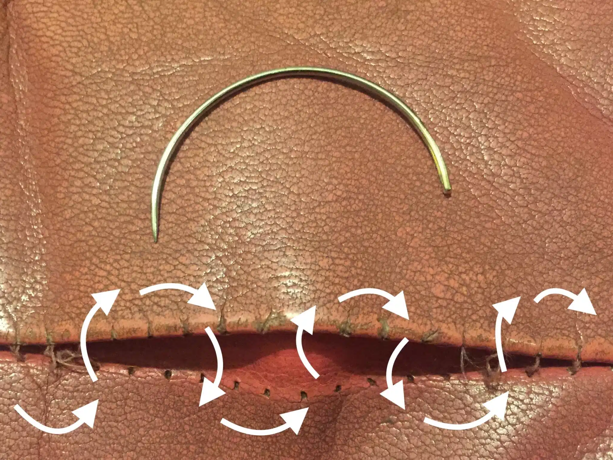 Picture of torn stitching on pink leather with with arrows depicting ladder stitch technique