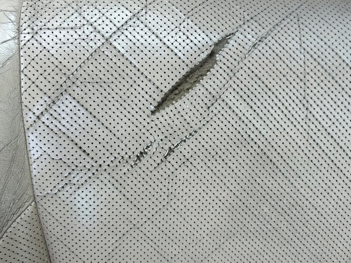 Picture of torn perforated leather car seat