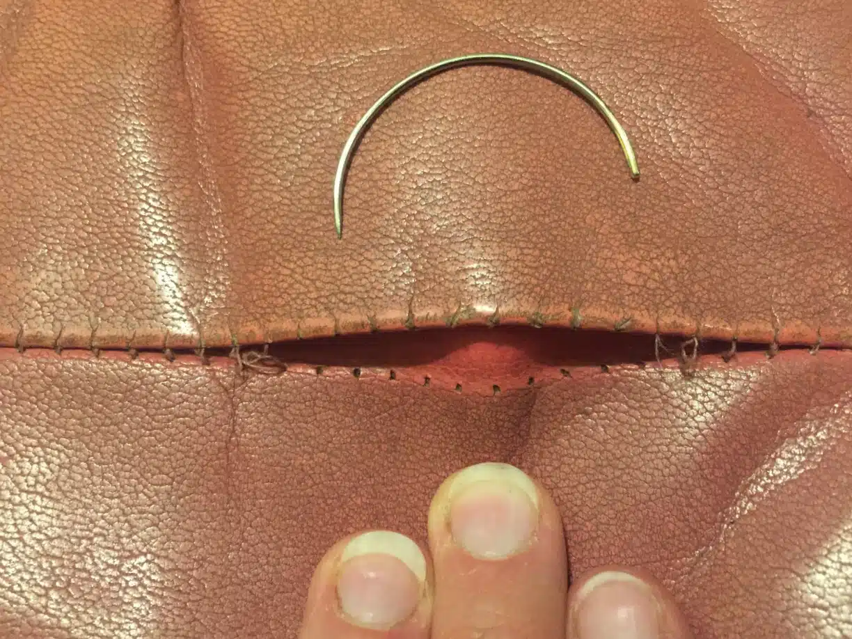 Picture of pink leather whose seam and stitching need sewing