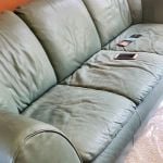 Photo of stained, faded Natuzzi leather couch