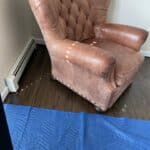 Picture of faded tufted leather chair