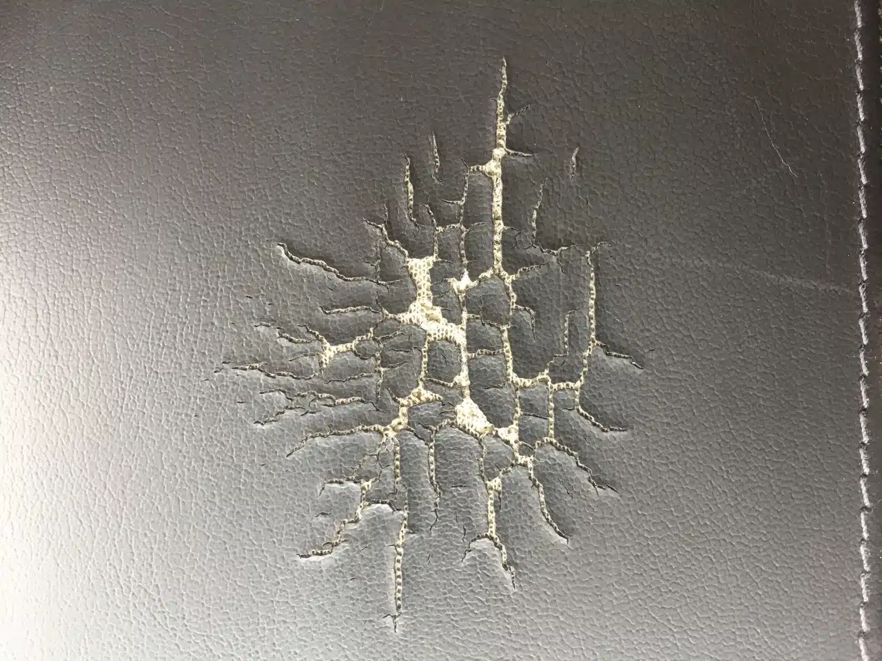 Picture of curling edges and spider web pattern when vinyl cracks