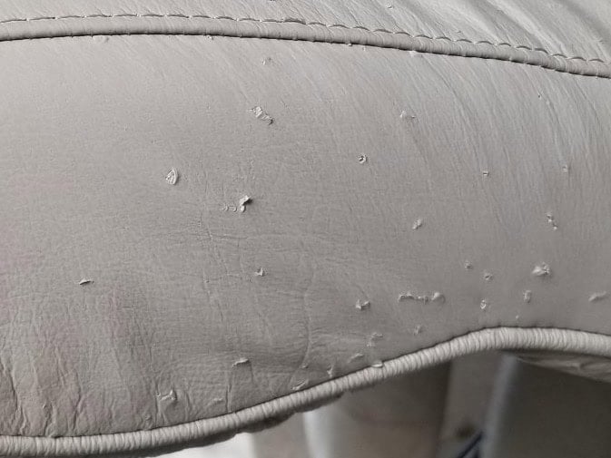 Picture of minor cat claw punctures on leather armchair