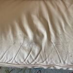 Close-up of leather couch cushion showing cracks and wear