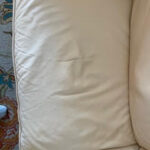 Close-up of leather couch cushion after repair of cracks with filler putty and Custom Color