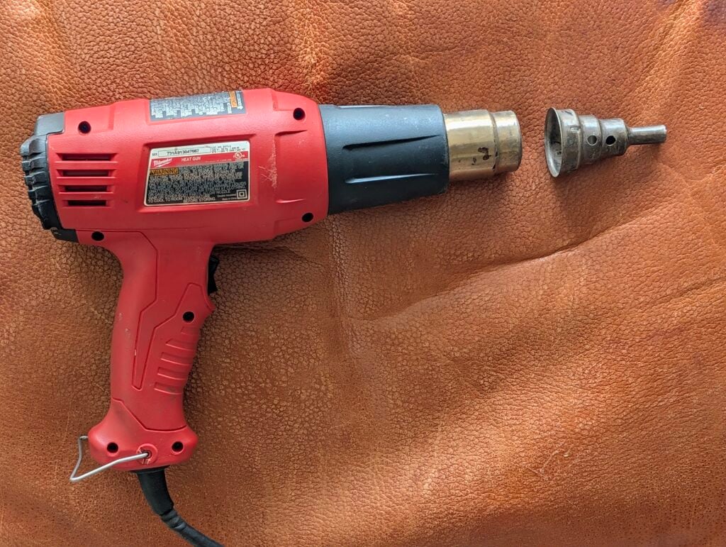 Picture of dual temperature heat gun and reducer nozzle used to cure plastisol putty when repairing vinyl and leather