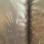 Image of cushion before restoration with pet scratches