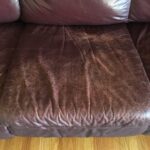 Close-up photo of wear on leather couch cushion