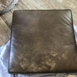 Picture of worn, discolored brown leather couch cushions