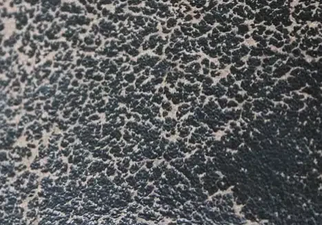 This leather is so worn that the skin's surface has cracked and exposed the underlying suede.