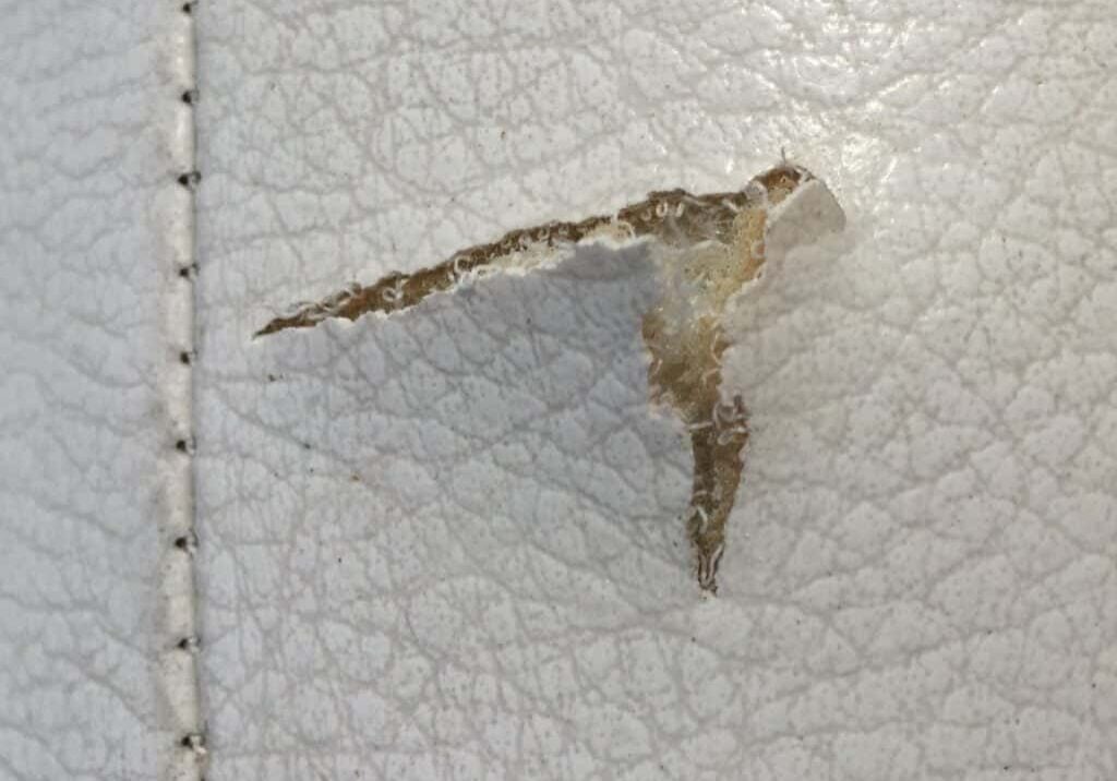 The tear in this boat vinyl needs to be subpatched before it can be fixed with filler.