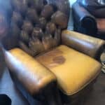 Photo of faded tufted leather chair