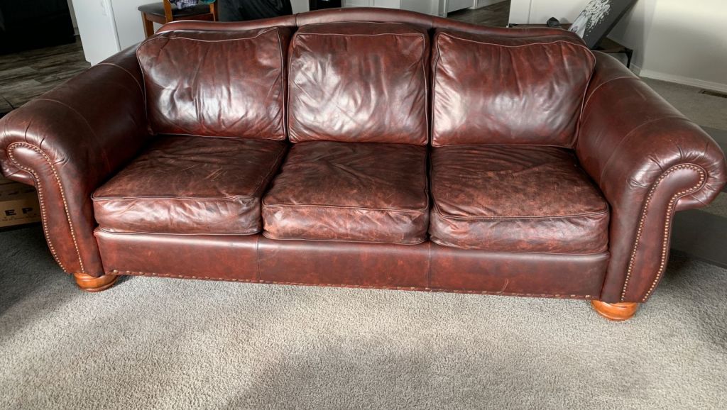 Picture of leather sofa damaged by mineral deposits after restoration