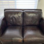 Picture of leather loveseat damaged by chemical cleaner