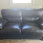 Brown leather couch with scratches and gouges