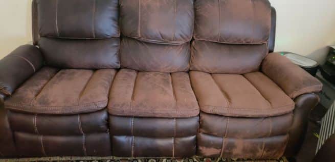 worn-faux-leather-couch-polyester-fabric-exposed